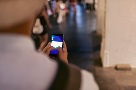 Close up View of Businessman with a Smart Phone in the City Streets During a Night