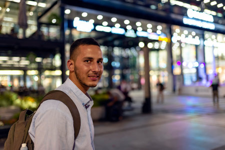 Young Handsome Man with Backpack Standing in the City Centerの写真素材