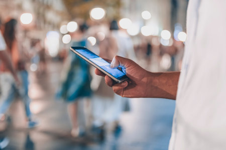 Close up View of Businessman with a Smart Phone in the City Streets During a Nightの写真素材