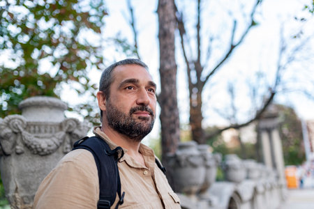 Portrait of Mid Aged Bearded Tourist Walking Down the City and Feeling Joyful and Confidentの写真素材