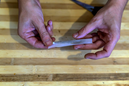 Preparing and Rolling Marijuana Cannabis Joint. Drugs Narcotic Concept. Close up.の写真素材