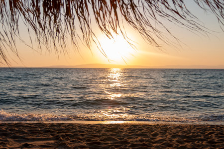 A tranquil beach bathed in a serene sunrise Nature composition.の写真素材