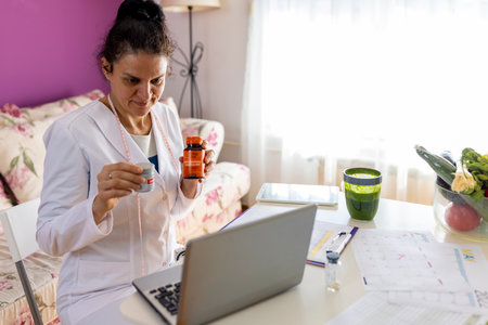 An experienced female nutritionist tells the patient about the benefits of a detox smoothie during an online session using a laptop.の写真素材