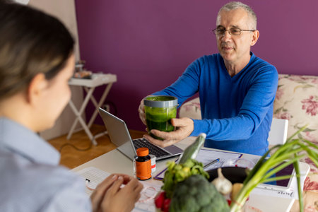 Nutrition expert talking to client about health problems and importance of eating healthy food.の写真素材