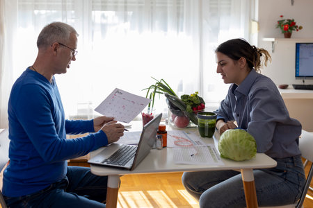 Doctor and female patient on consultation in the office.の写真素材
