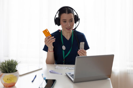 Portrait of doctor talking to online patient at clinic office giving online consultation for domestic health treatment. Healthcare and medicine.の写真素材