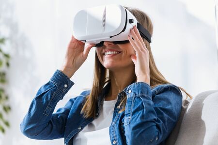 Portrait of beautiful young woman using virtual reality headset.