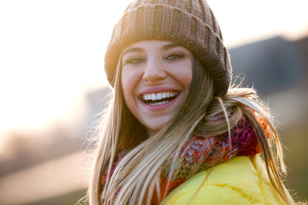 Portrait of beautiful young woman looking at camera in the park.の写真素材