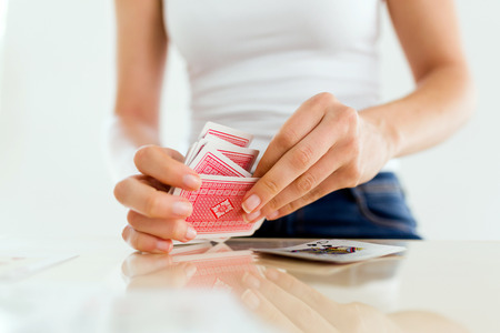 Close-up of young woman's hands mixing and treating poker cards.の写真素材