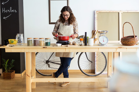 Shot of beautiful young woman cooking in organic store.