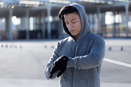 Portrait of fit and sporty young man relaxing after work out in the city.の写真素材