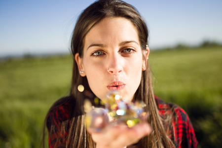 Portrait of beautiful young woman enjoying spring in a field.