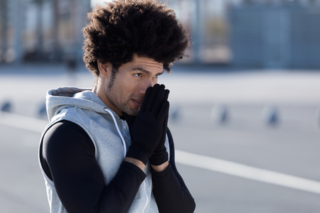 Portrait of fit and sporty young man relaxing after work out in the city.の写真素材