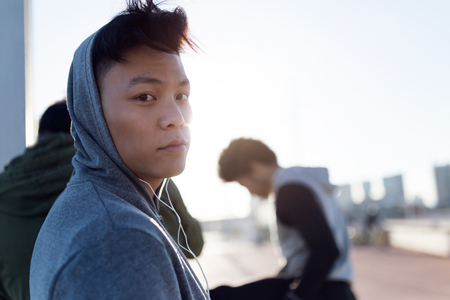 Portrait of fit and sporty young man looking at camera in the city.の写真素材