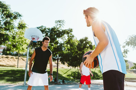 Outdoor portrait of group of friends playing basketball on court.の写真素材