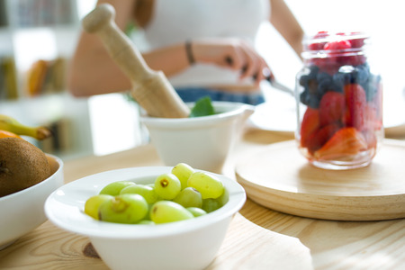 Portrait of beautiful young woman preparing breakfast at home.の写真素材