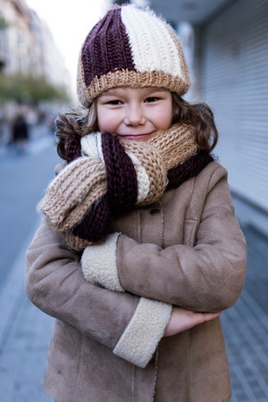 Portrait of happy young girl posing in the street.の写真素材