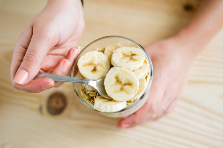 Portrait of beautiful young woman enjoying breakfast at home.の写真素材