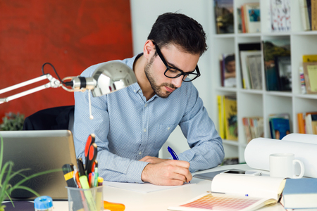 Portrait of handsome young businessman working in the office.の写真素材
