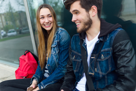 Portrait of two students talking in the street after class.の写真素材