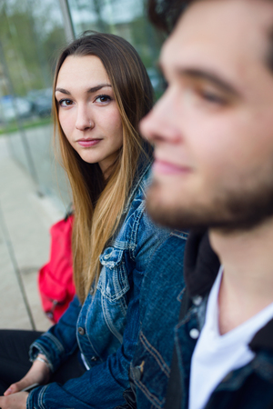 Portrait of two students talking in the street after class.の写真素材