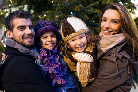 Portrait of happy young family having fun in the street.の写真素材
