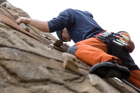 Portrait of handsome young man climbing natural rocky wall.の写真素材