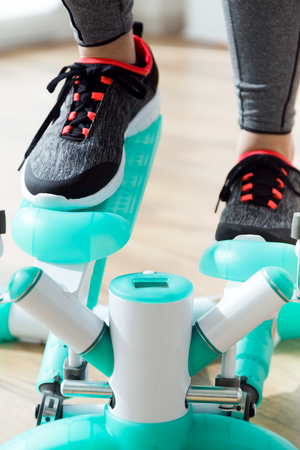 Portrait of beautiful sporty young woman doing exercise in gym.の写真素材