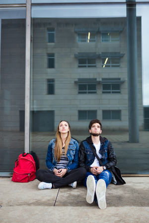 Portrait of two students talking in the street after class.の写真素材