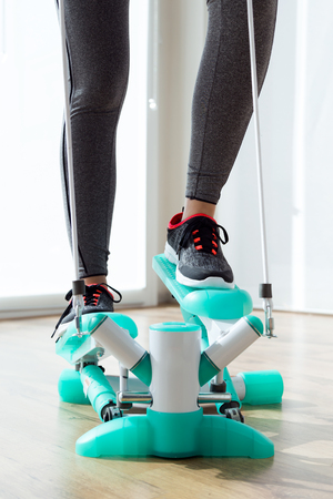 Portrait of beautiful sporty young woman doing exercise in gym.の写真素材