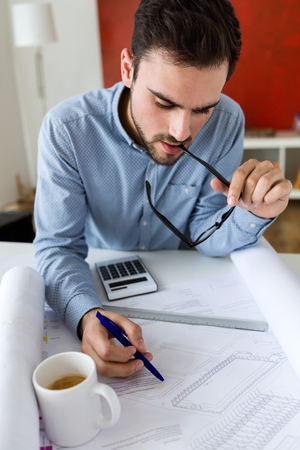 Portrait of handsome young businessman working in the office.の写真素材