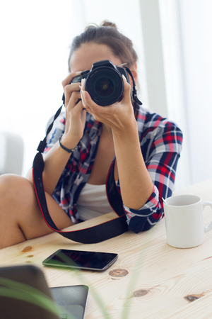 Portrait of young woman photographer taking a photography in the studio.の写真素材
