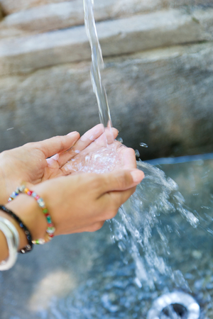 Portrait of woman's hands with water splash.の写真素材