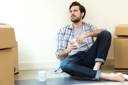 Portrait of Young man resting during the move to their new home
