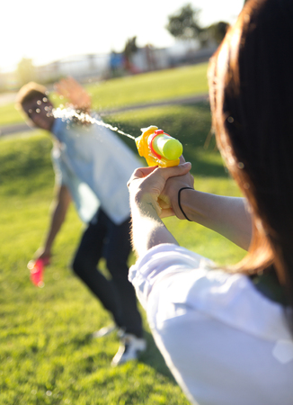 Happy young couple having fun in a parkの写真素材