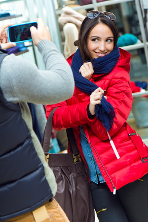 Portrait of beautiful couple shopping in a clothes shop.の写真素材