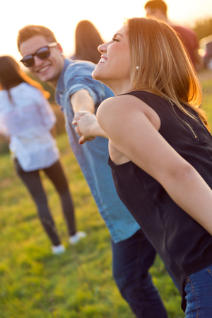 Outdoor portrait of group of friends having fun in field.の写真素材