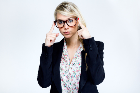 Portrait of a beautiful young teacher woman with glasses thinkingの写真素材