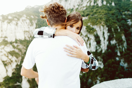 Portrait of beautiful young couple enjoying nature on mountain.の写真素材