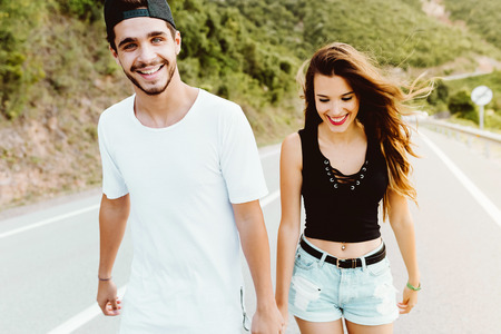 Portrait of beautiful young couple enjoying nature on mountain.の写真素材