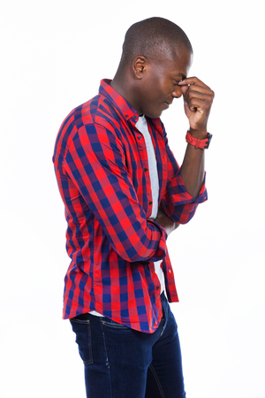 Portrait of handsome young man covering her face over white background.の写真素材