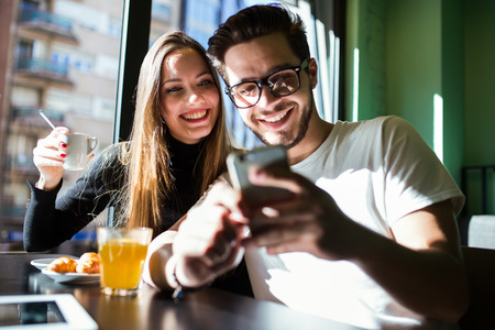 Portrait of beautiful young couple having a break time in the coffee.