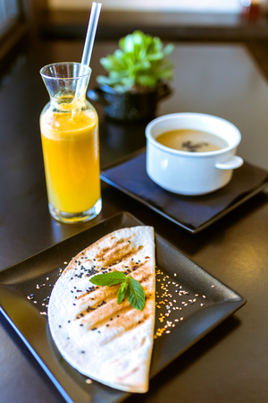 Close-up of healthy food and orange juice in a restaurant.の写真素材