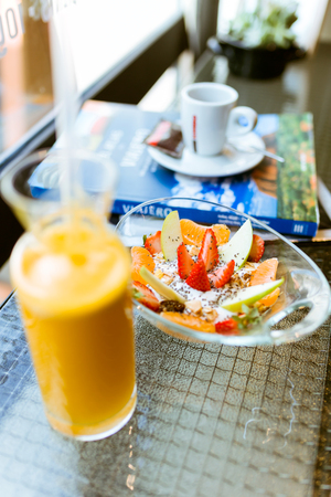 Close-up of healthy yogurt with fruits and orange juice in a restaurant.の写真素材