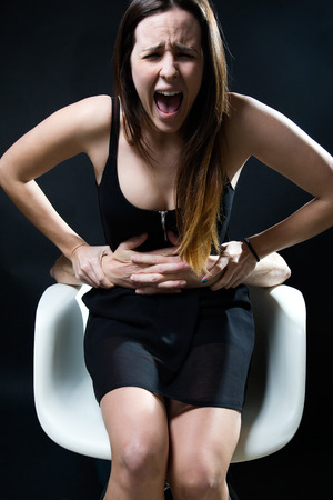 Portrait of young woman in a chair caught by a male arms. Concept of oppression.の写真素材