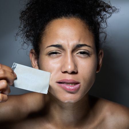 Black woman with mouth covered with tape
