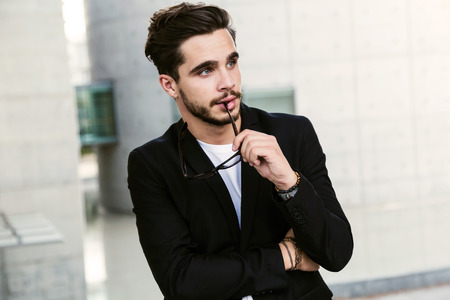 Portrait of handsome young man posing in the street.の写真素材