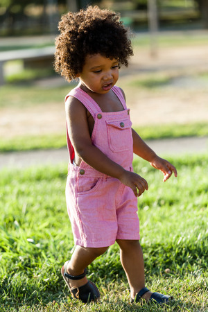 Portrait of a african american baby having fun in the park.の写真素材