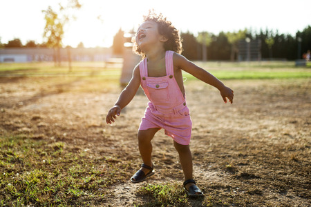 Portrait of a african american baby having fun in the park.の写真素材