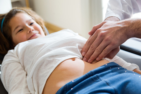 Portrait of girl being examined by pediatrician in the office.の写真素材